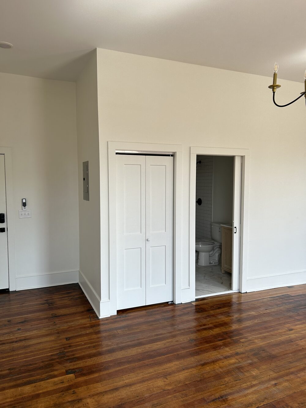 Closet and bath entry with hardwood floors